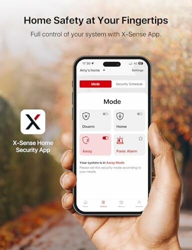 Hand holding smartphone displaying X-Sense Home Security App with mode settings.