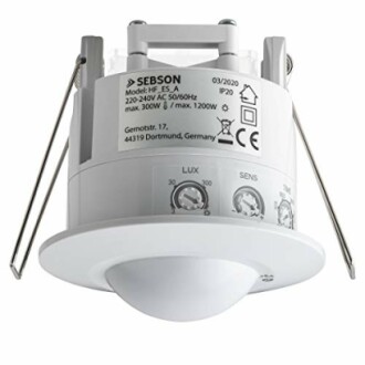 Ceiling-mounted motion sensor with labeled settings and wiring.